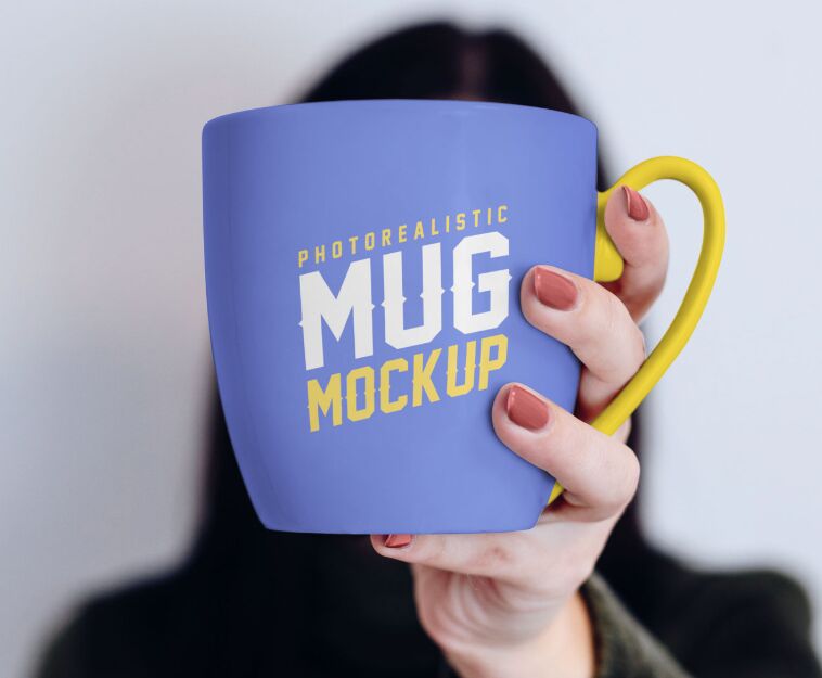 Free Mug in Female Hand Mockup PSD